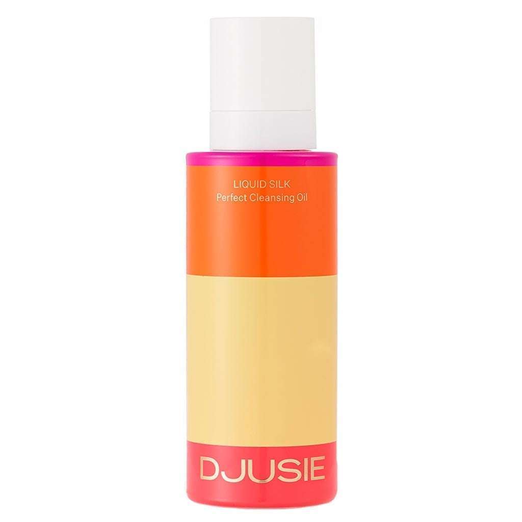 Una bottiglia di Djusie Liquid Silk Perfect Cleansing Oil di Djusie, caratterizzata da un design a blocchi di colore arancione brillante, beige e rosa con tappo bianco, ideale per rimuovere il trucco waterproof.