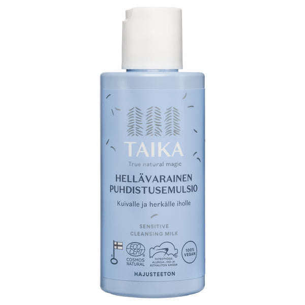 Un flacone azzurro di Taika Sensitive Cleansing Milk per pelli secche e sensibili, con testo in finlandese e inglese, loghi di certificazione e tappo flip-top bianco.